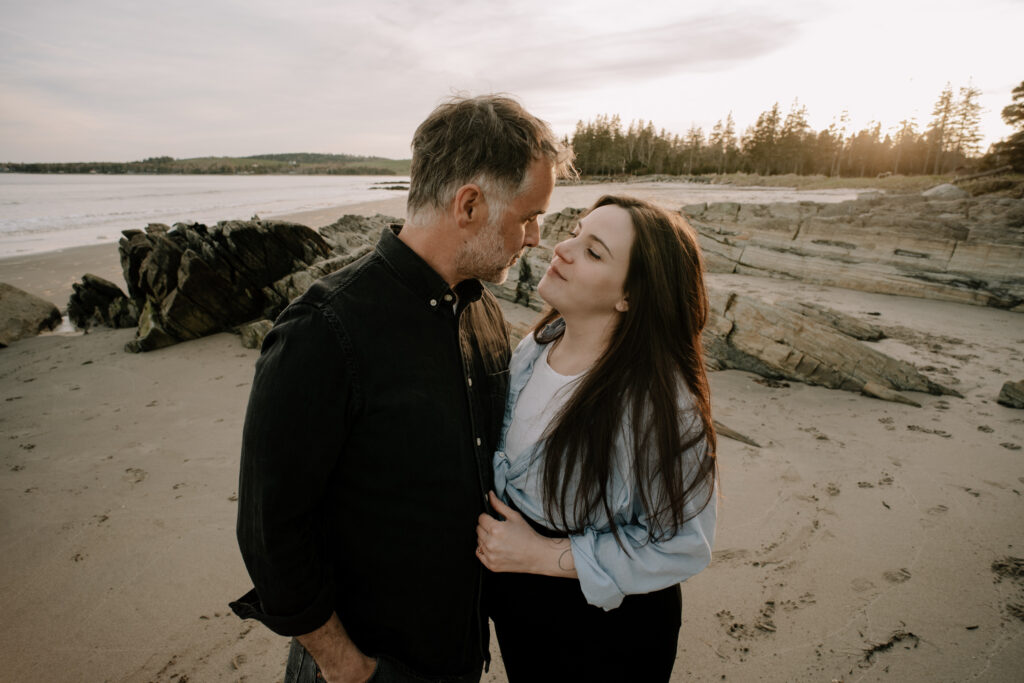 Intimate candid moment between couple on Rissers Beach in Nova Scotia