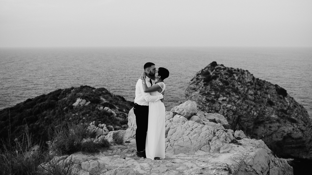 First kiss between bride and groom during intimate wedding in Valencia, Spain.
