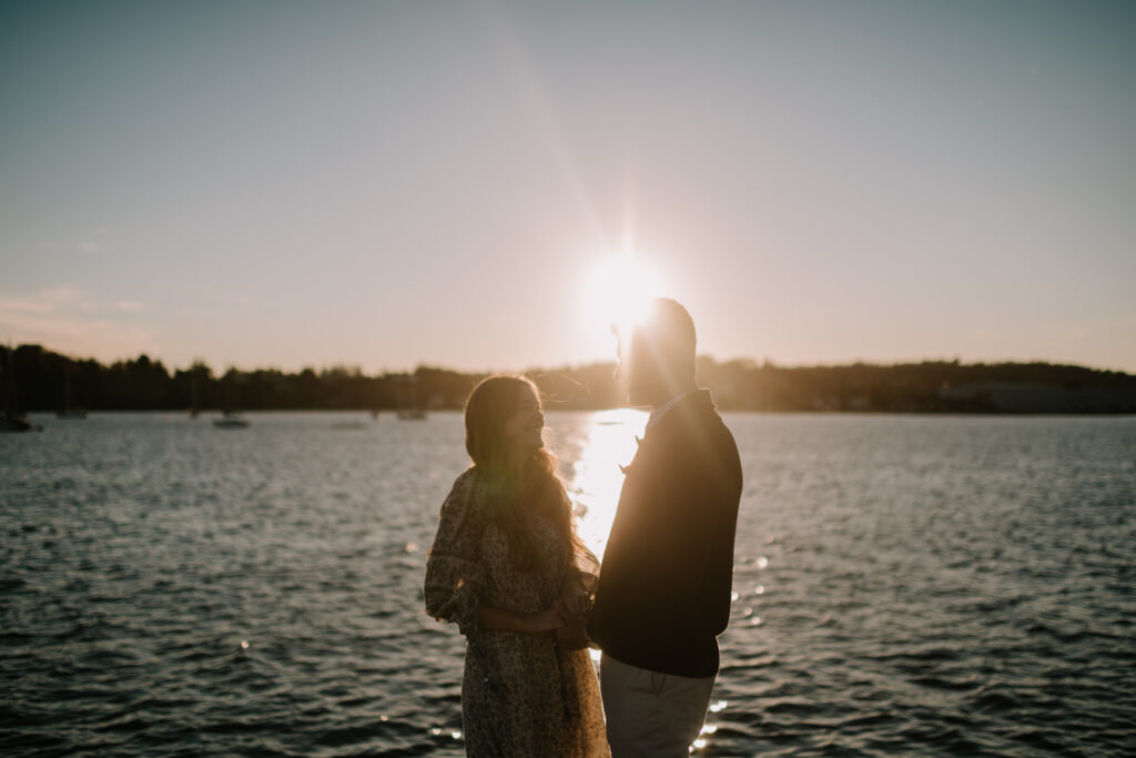 Couple at sunset by water in Nova Scotia