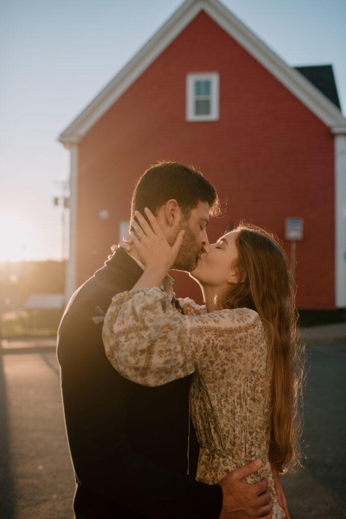 Couple kissing in front of colourful house in Lunenburg