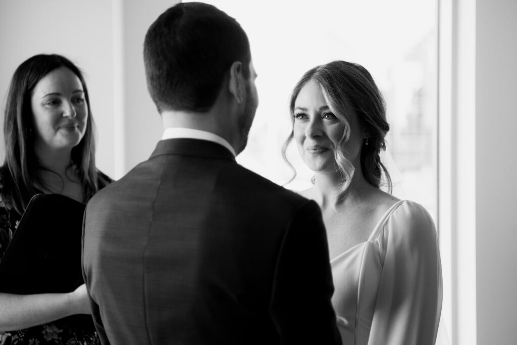 Bride looking lovingly at groom during wedding ceremony shot by Nova Scotia Wedding Photographer