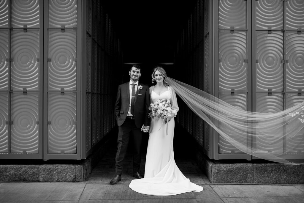 Wedding couple portrait in front of Muir Hotel photographed by Nova Scotia Wedding Photographer in Halifax Harbour