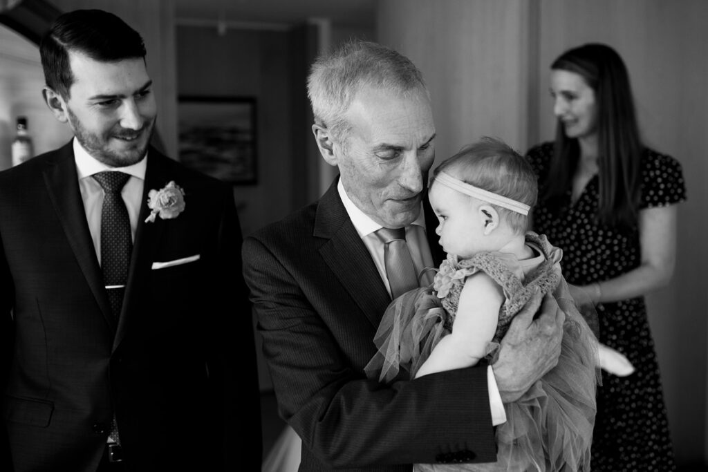 Father of the groom holding baby at Halifax Wedding