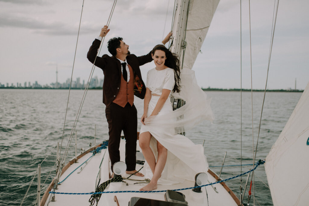 Candid moment of bride and groom sailing on wedding day. Photographed by Nova Scotia Wedding Photographer.