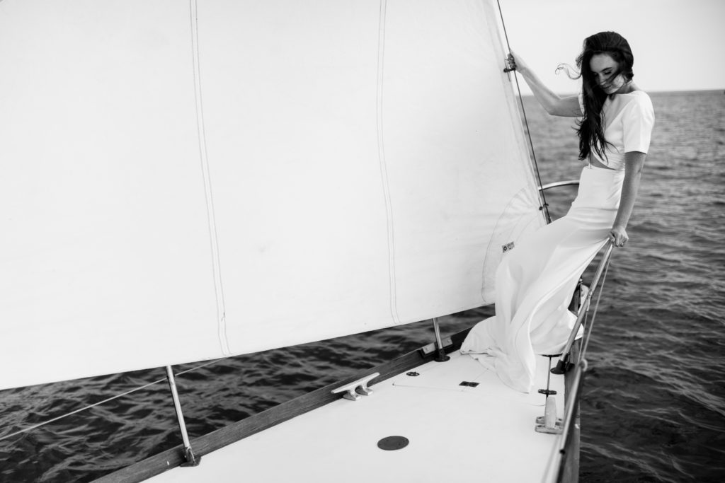 Black and white wedding photo of bride on sailboat in Nova Scotia.
