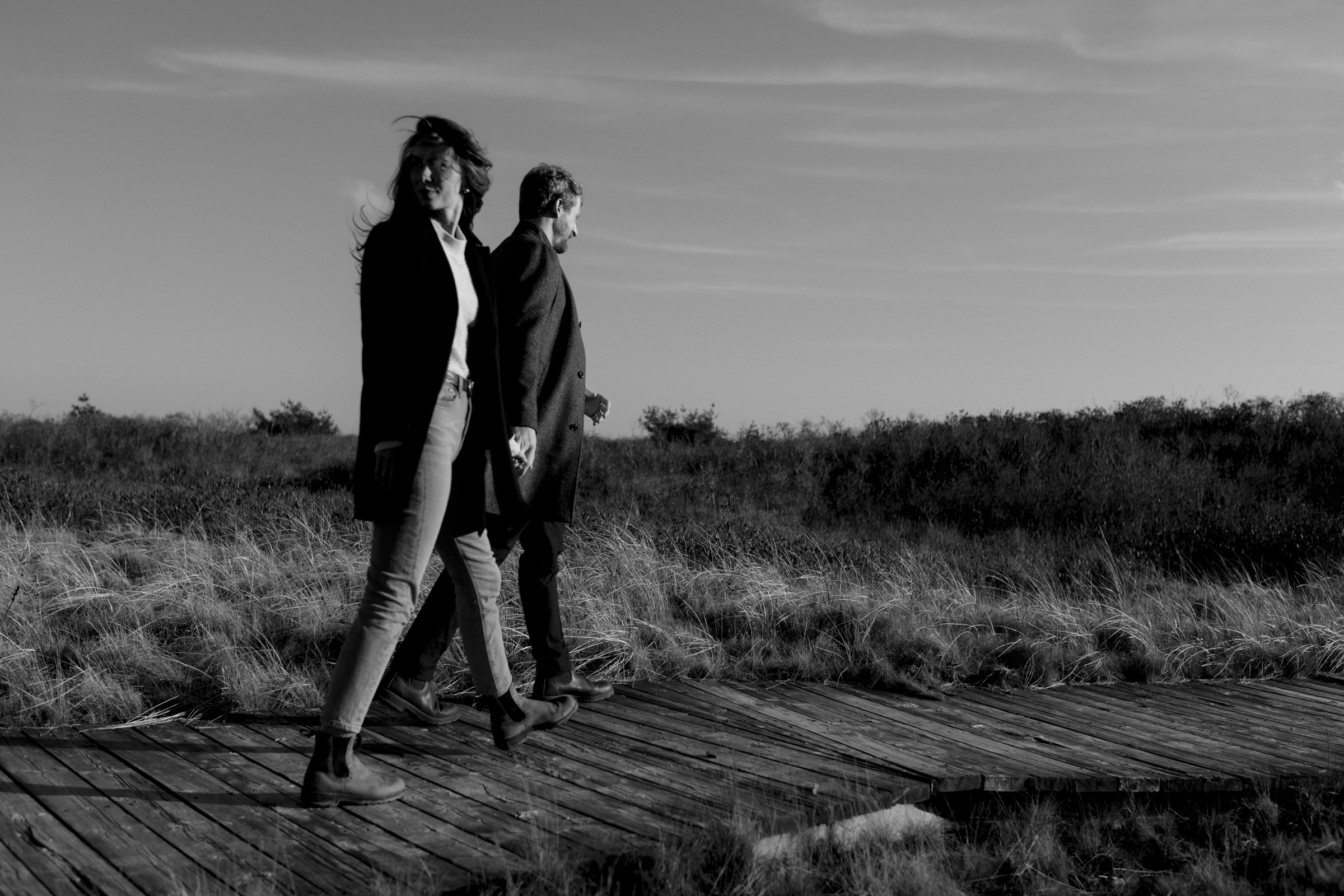 Couple walking on boardwalk at Summerville beach