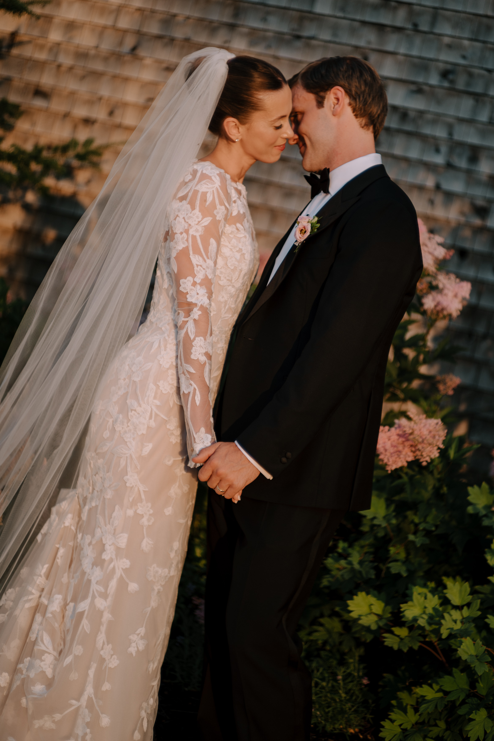 Bride and groom almost kissing.